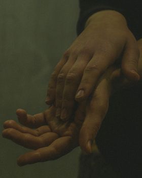 Intimate close-up of hands conveying love and connection. Perfect for themes of affection and togetherness.