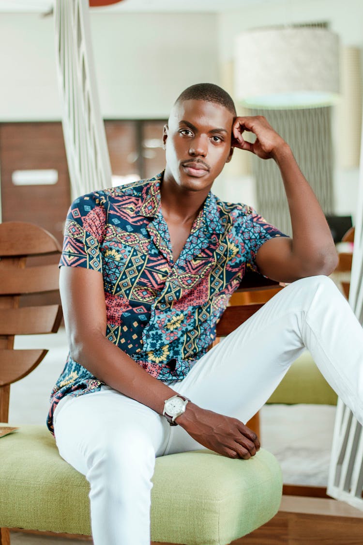 Man In Colorful Shirt Resting Head On Hand