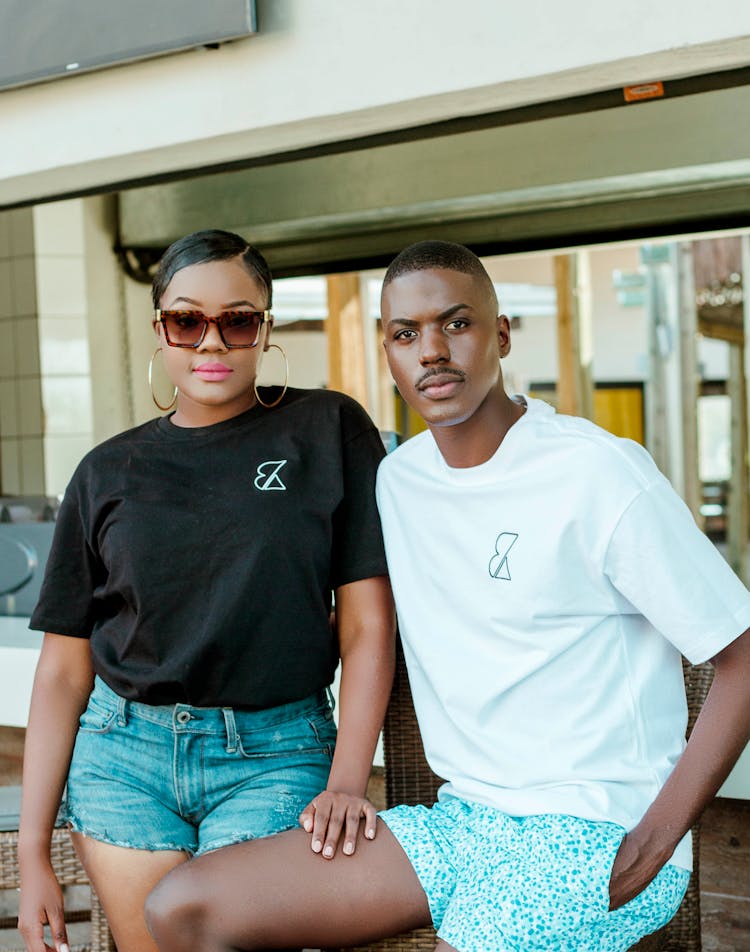 Woman In Sunglasses Standing With Hand On Thigh Of Man