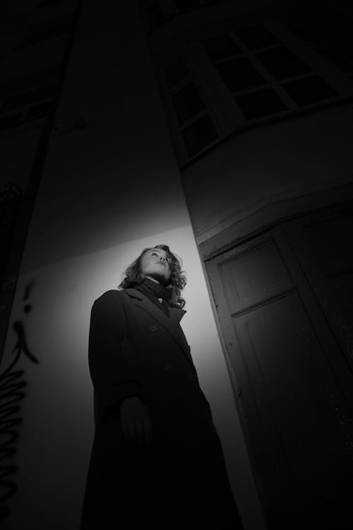 Monochrome Photo of Woman in Black Coat Standing