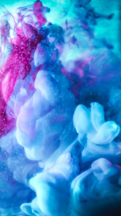 Free Abstract underwater ink swirl with vibrant blue and purple hues, creating a mesmerizing visual effect. Stock Photo