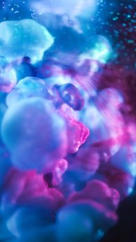 Dynamic abstract image with vibrant blue and pink colors, capturing fluid motion and artistic depth.