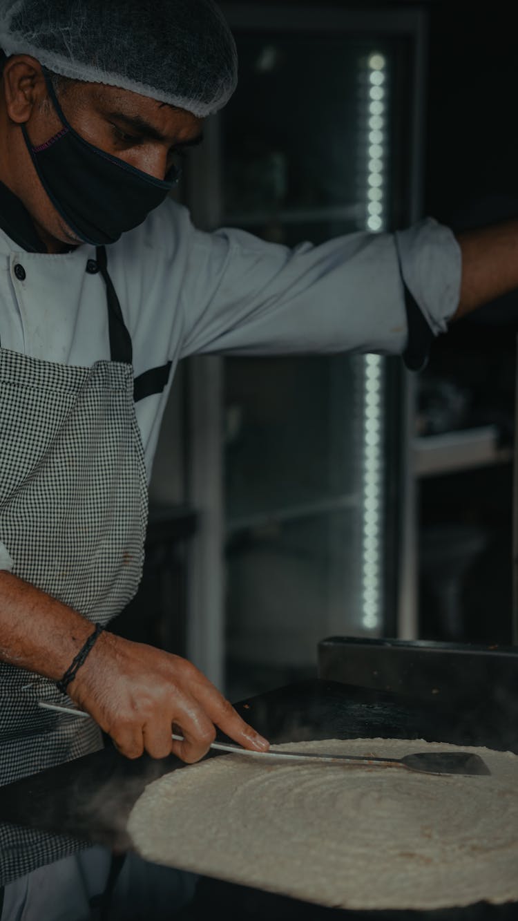 A Chef Making A Dosa