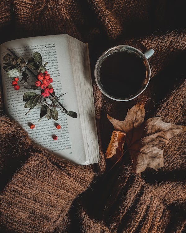 A Cup of Coffee beside an Open Book · Free Stock Photo