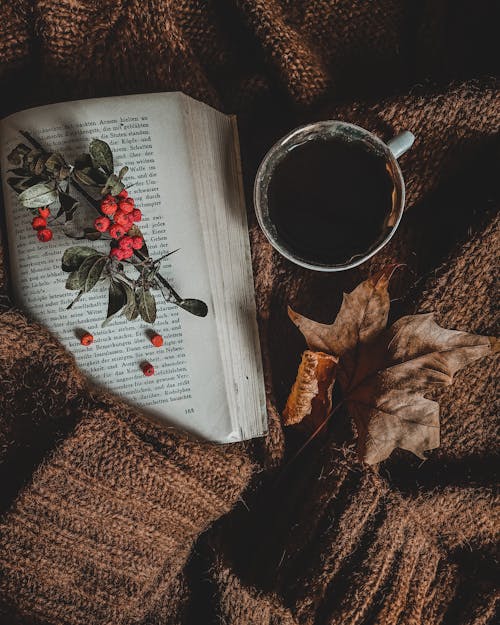 A Cup of Coffee beside an Open Book