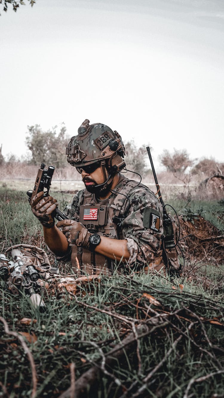 Soldier Camouflaging And Holding A Gun