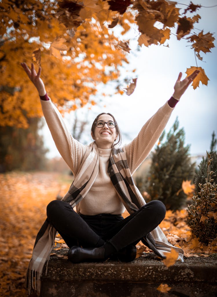 Woman Throwing Autumn Leaves 