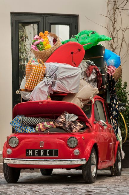 Taxi driver in Anguilla helping a family load luggage into a spacious vehicle
