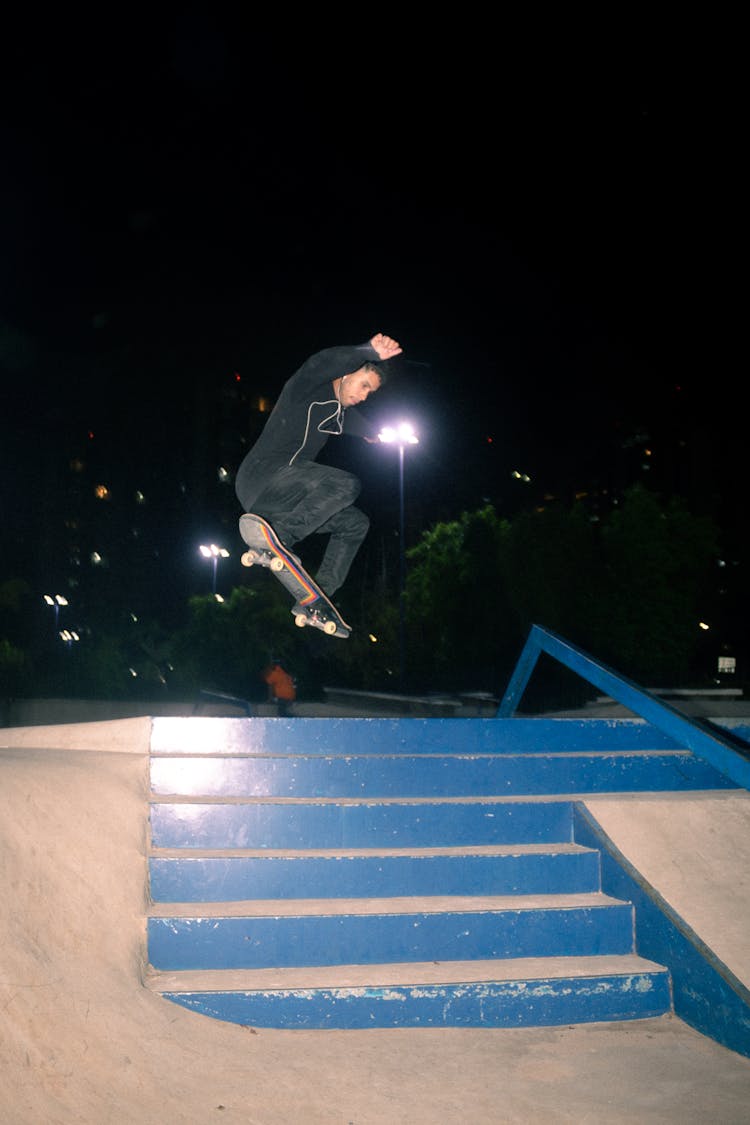 Man Jumping Over Stairs In Skatepark