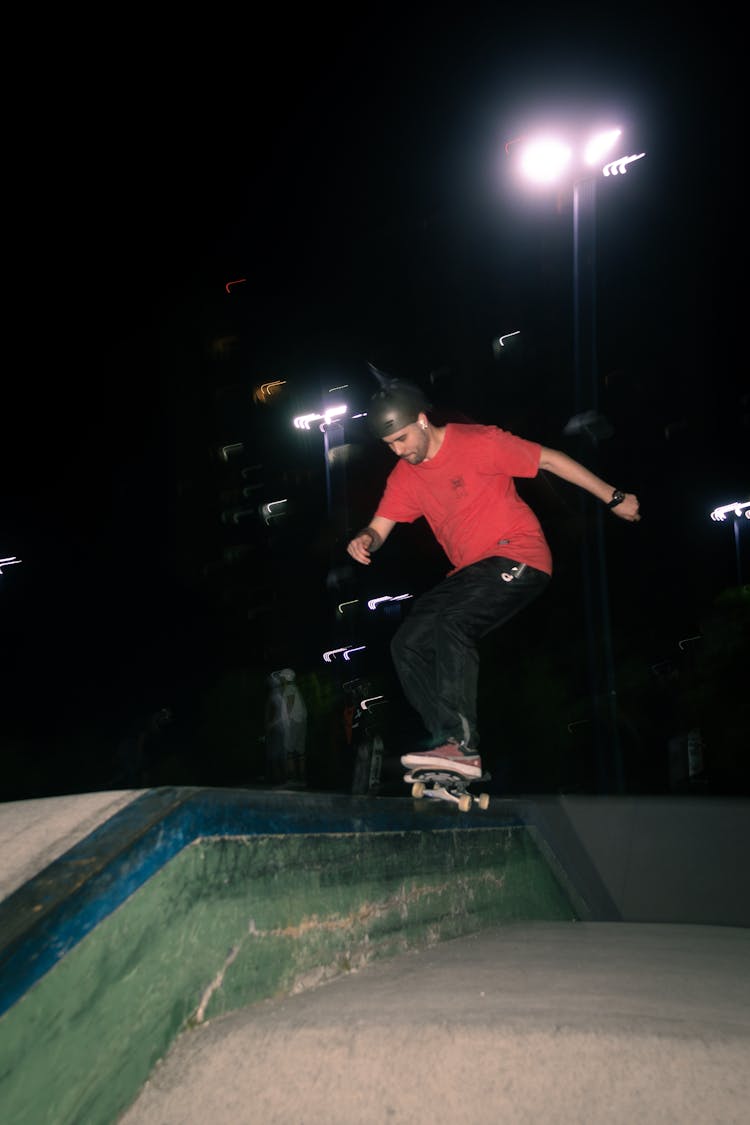 Man Skateboarding At Night