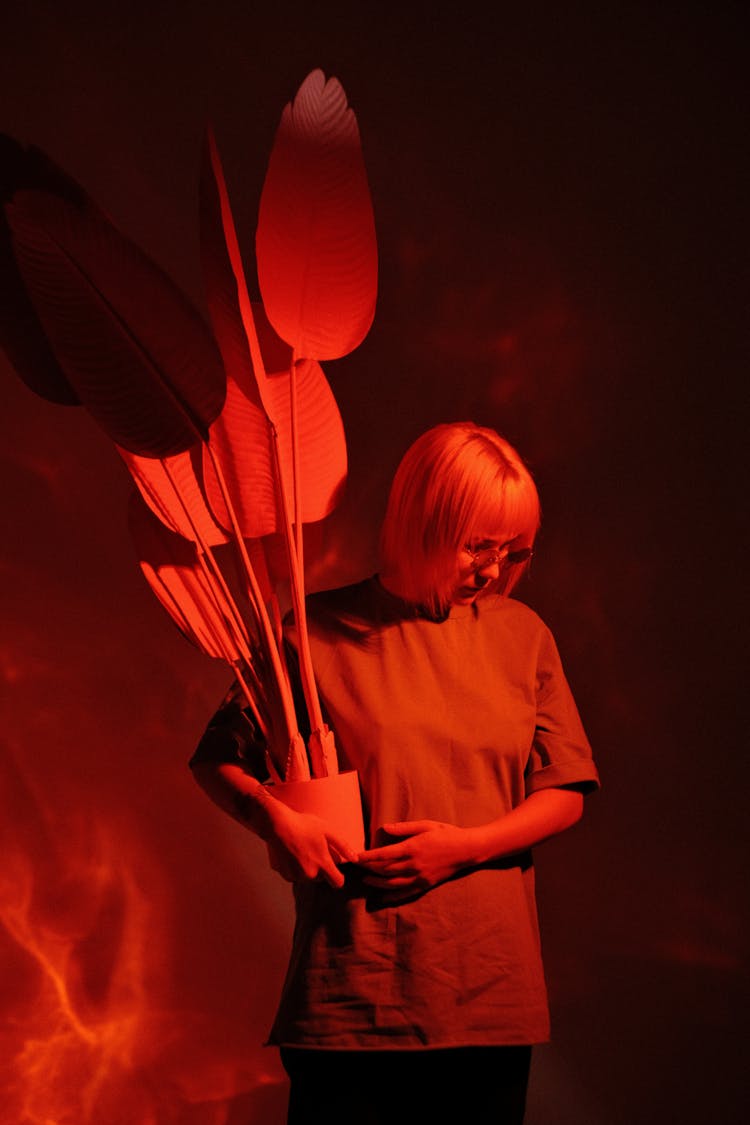 Portrait Of Woman Holding Plant