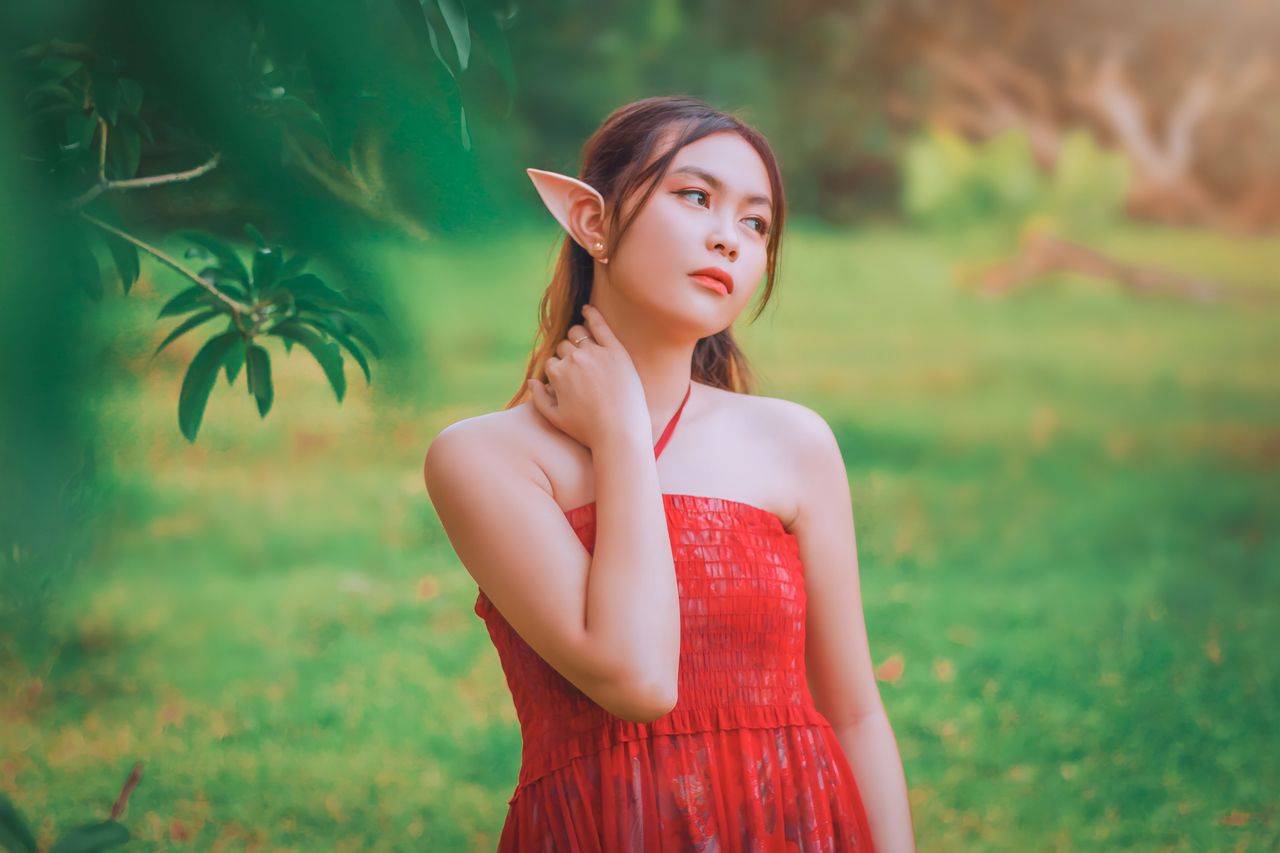 enchanting portrait of a young woman cosplaying as an elf in a lush ou