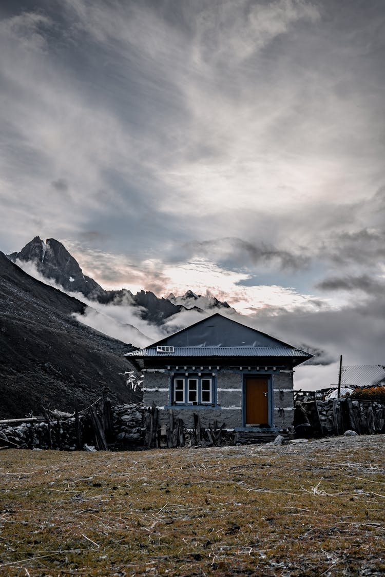 Clouds Over House In Mountains