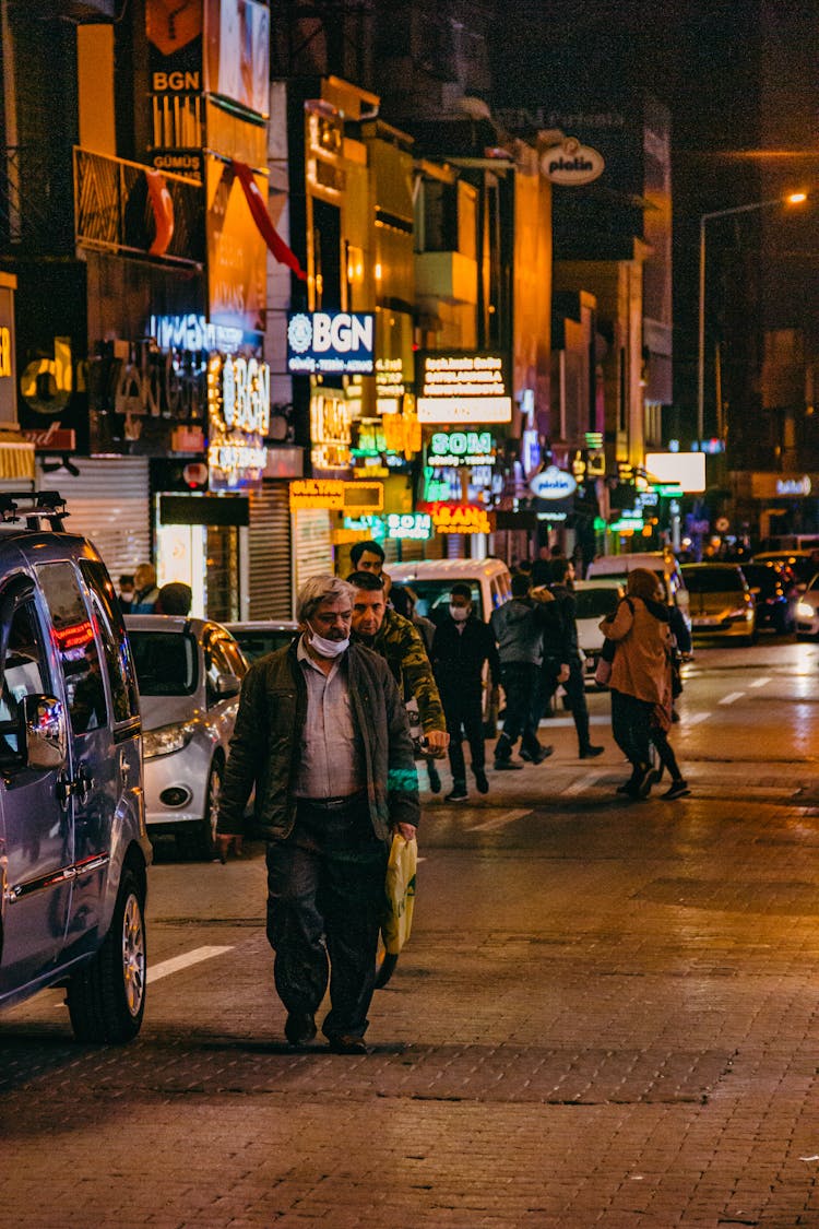 People Walking In Street At Night