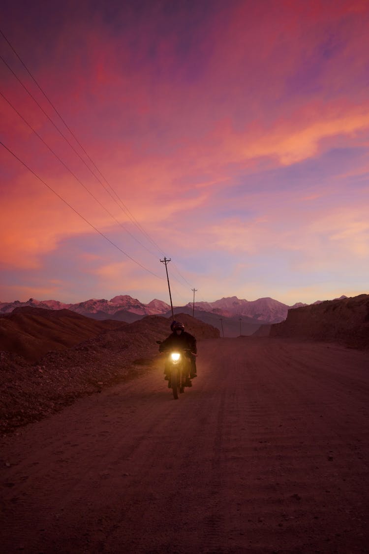 Motorcycle On Road At Sunset