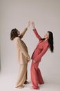 Women in Oversized Clothes Striking Symmetrical Poses