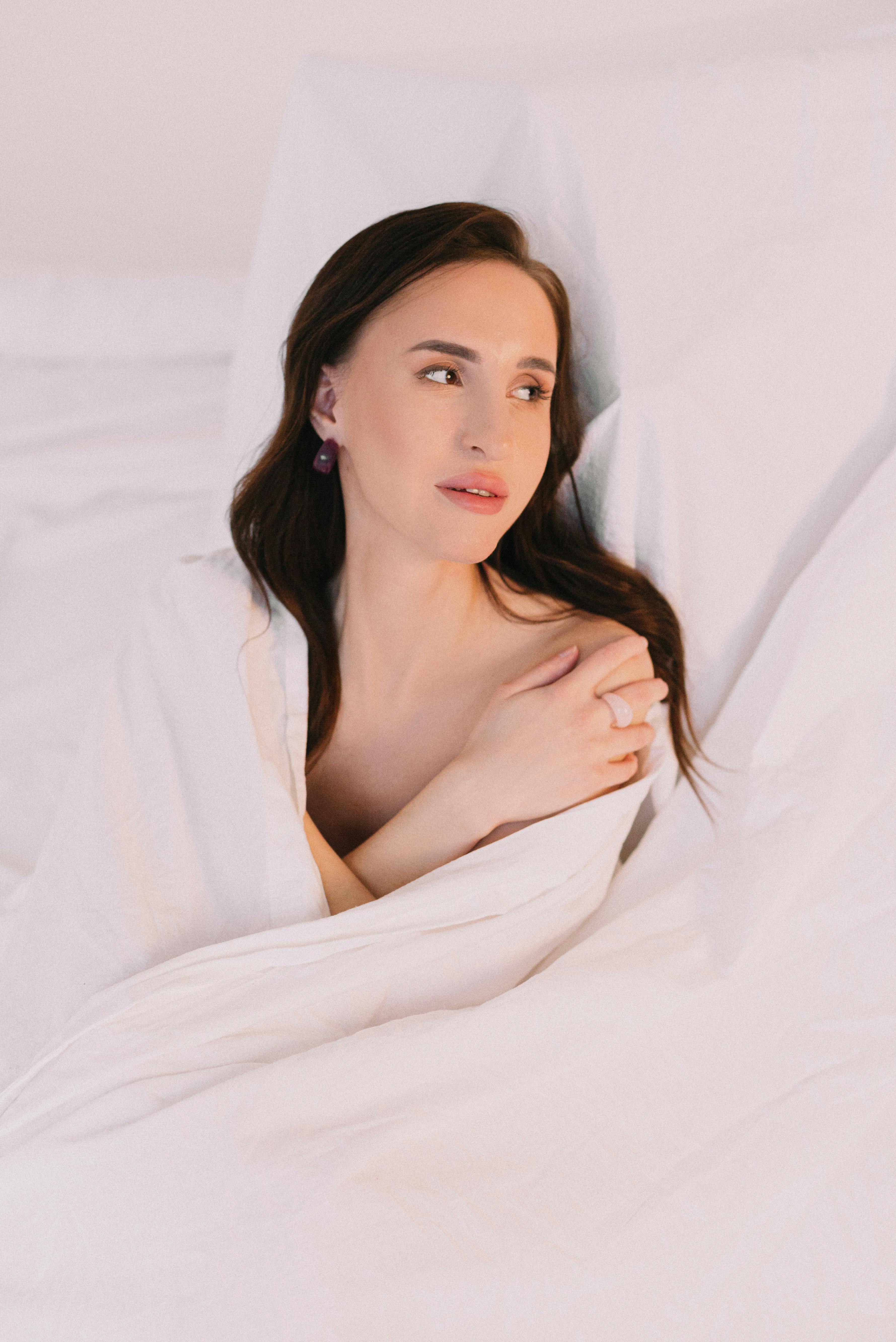 A Naked Woman Covering Herself with a Blanket · Free Stock Photo