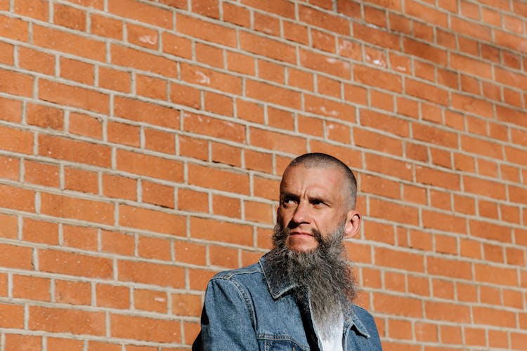 Adult Bearded Man Posing On Brick Wall Background