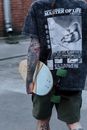  Unrecognizable Skateboarder wearing T-shirt and Shorts Holding Skateboard