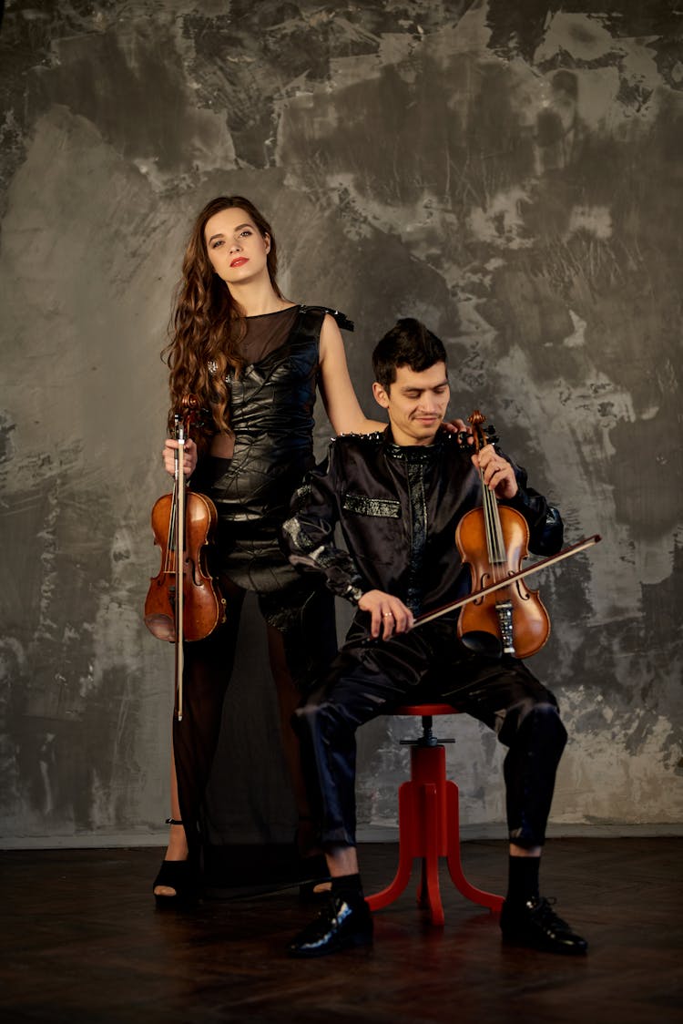 Couple Posing With Violins