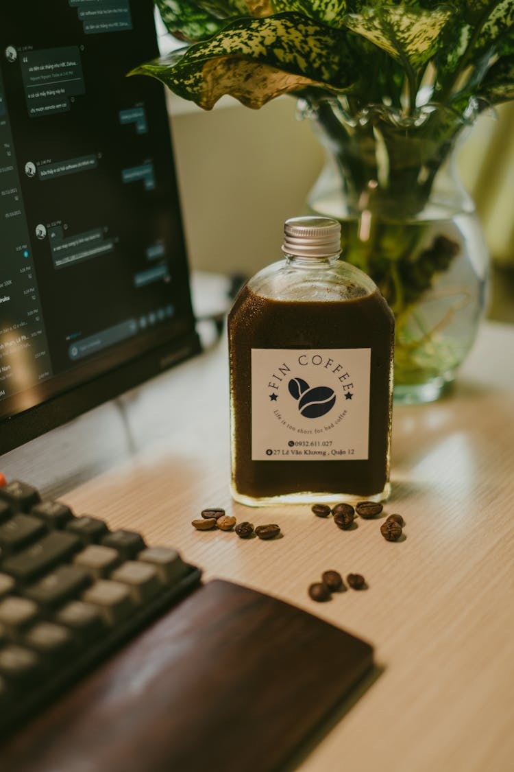 Coffee Bottle Near Screen