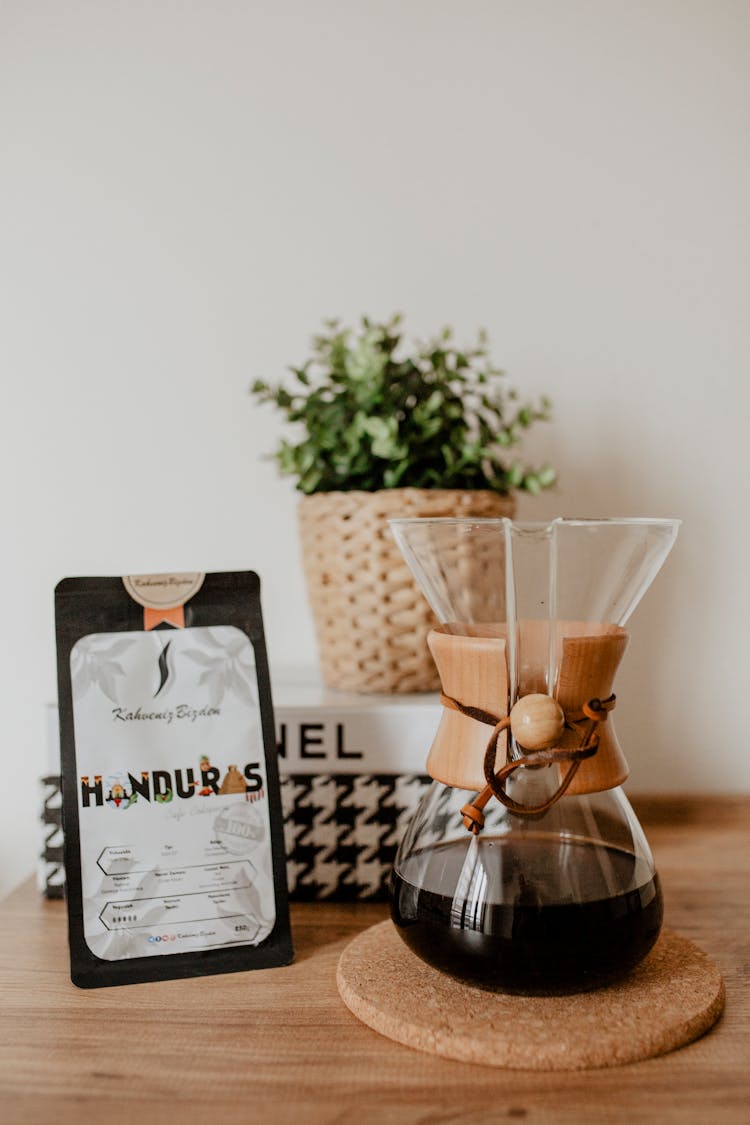 Table With Black Liquid In Glass Container