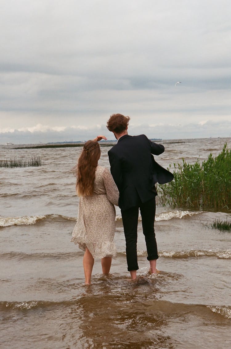 Newlywed Couple Walking In Sea