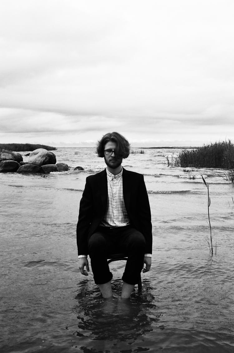 Man Posing On Chair In Water