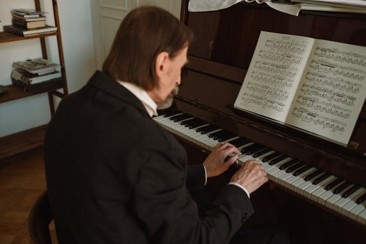 Elderly Man In A Suit Playing The Piano