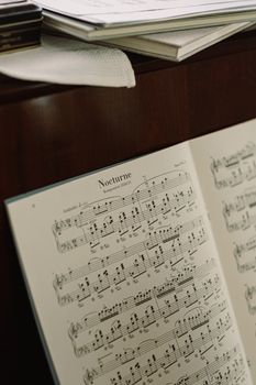 Close-up of sheet music titled 'Nocturne' on a piano, showcasing musical notes.