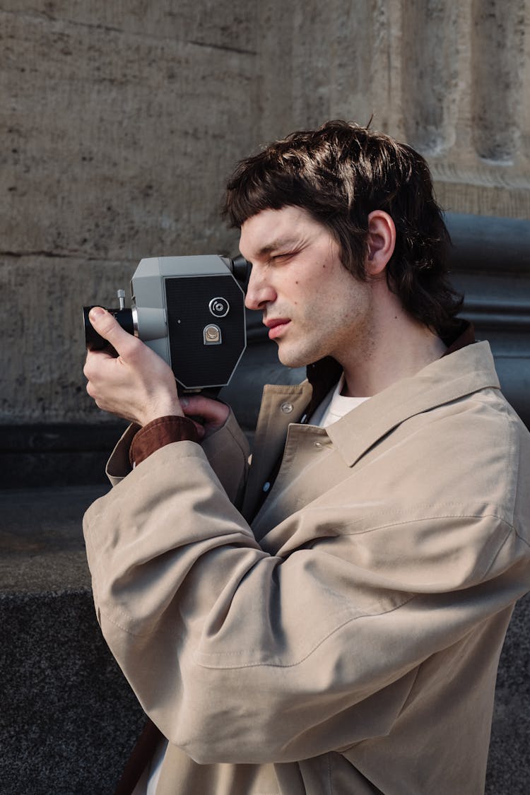 Man Filming With Analog Camera