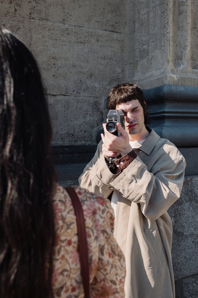 Man Filming Woman With Analog Camera