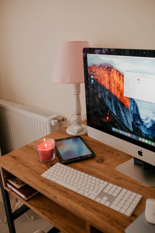 Free Apple Computer on a Wooden Desk Stock Photo