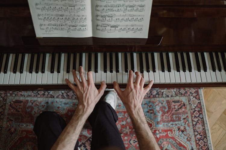 Hands On A Piano Keyboard