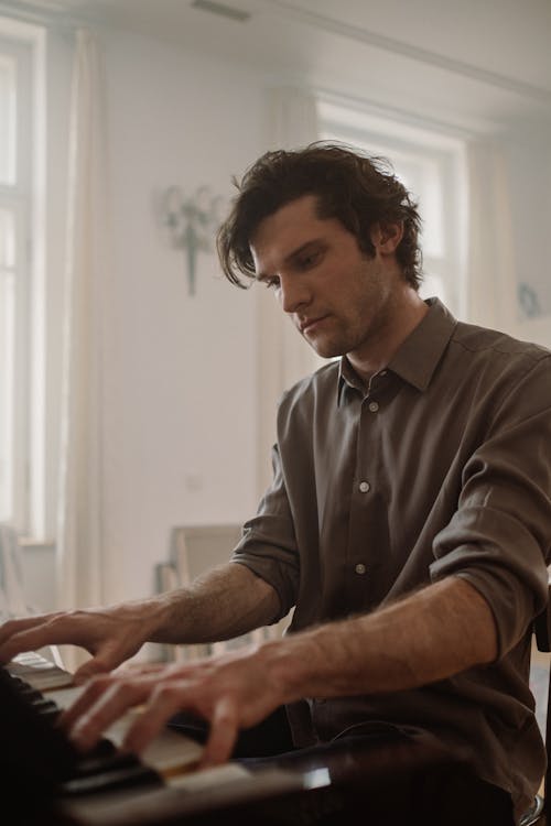Man Wearing Long Sleeve Shirt Playing Piano