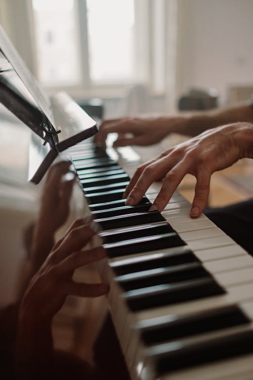 Person's Hands on a Piano