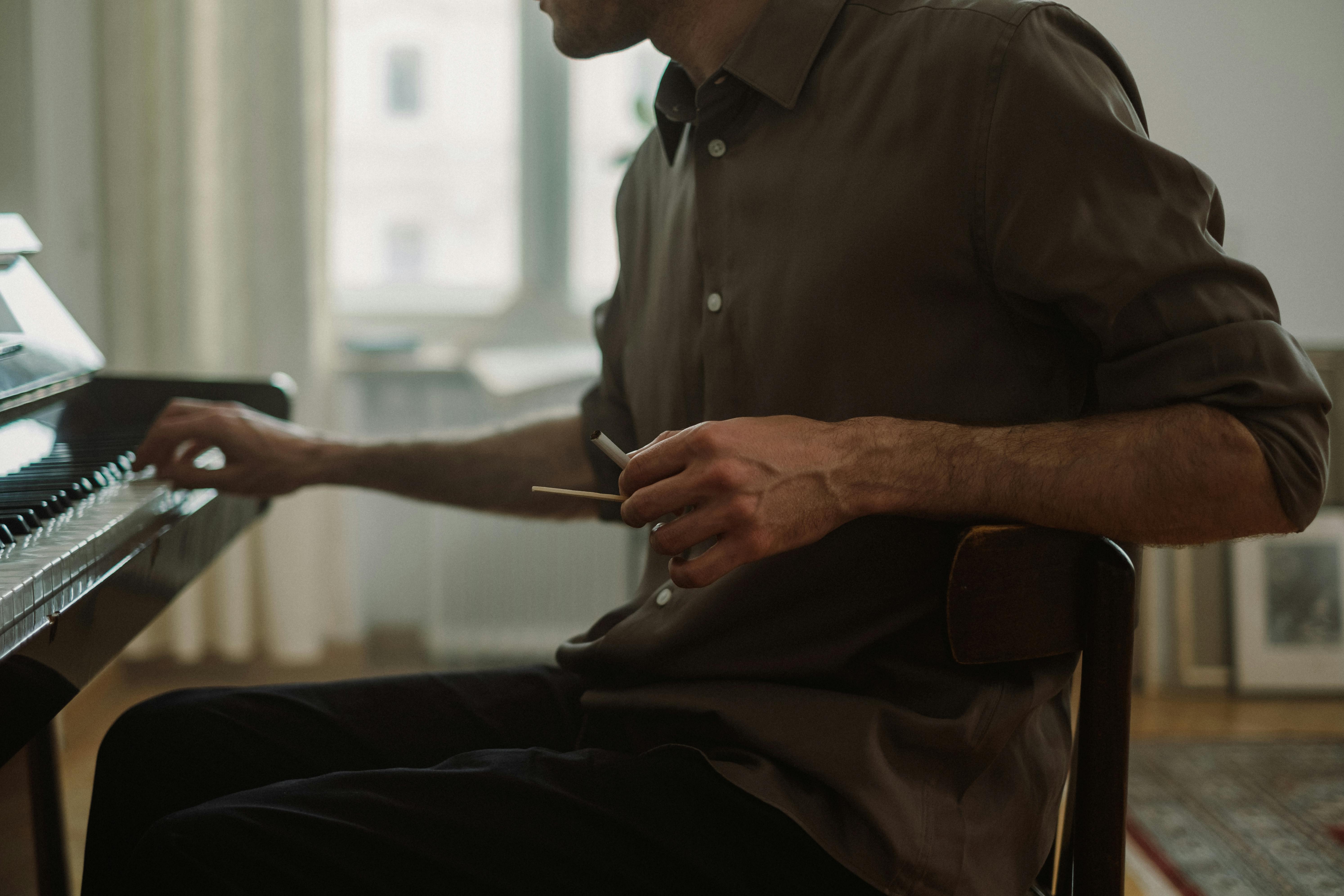 a man sitting on a chair while playing piano