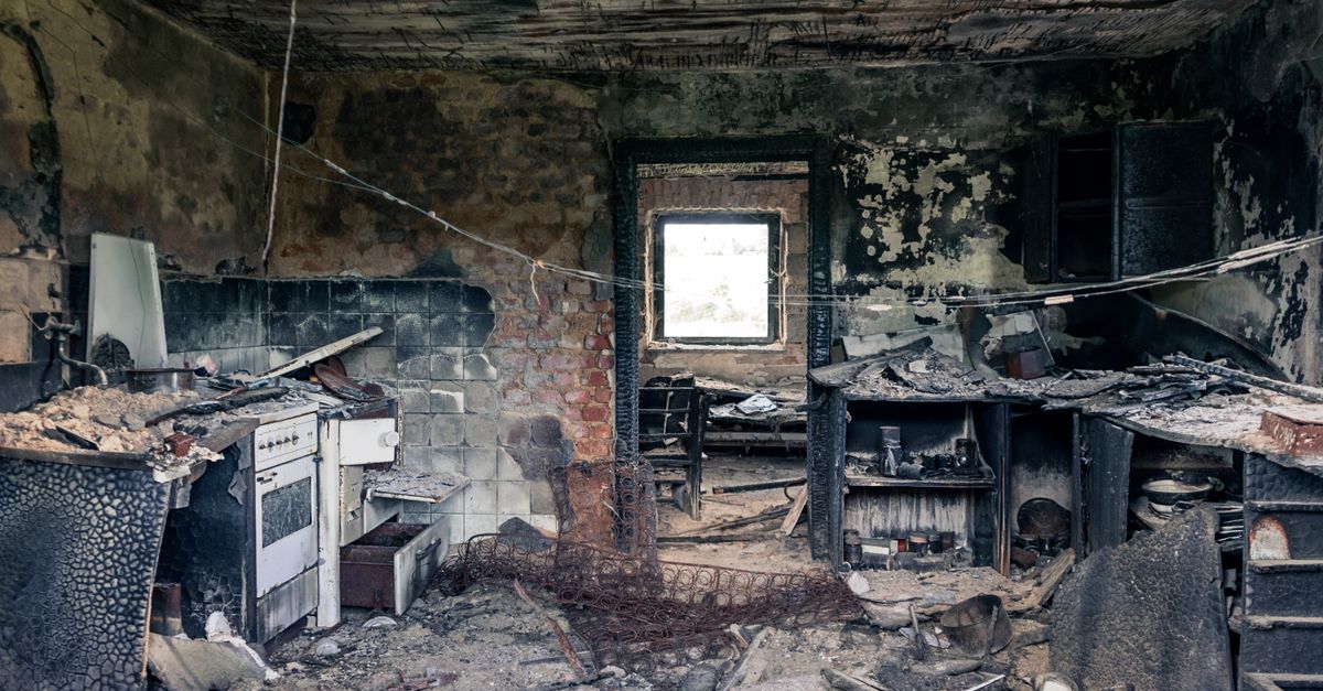 Explore an abandoned, fire-damaged kitchen illustrating decay and destruction.