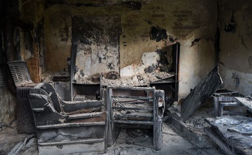 Charred room with fire-damaged furniture