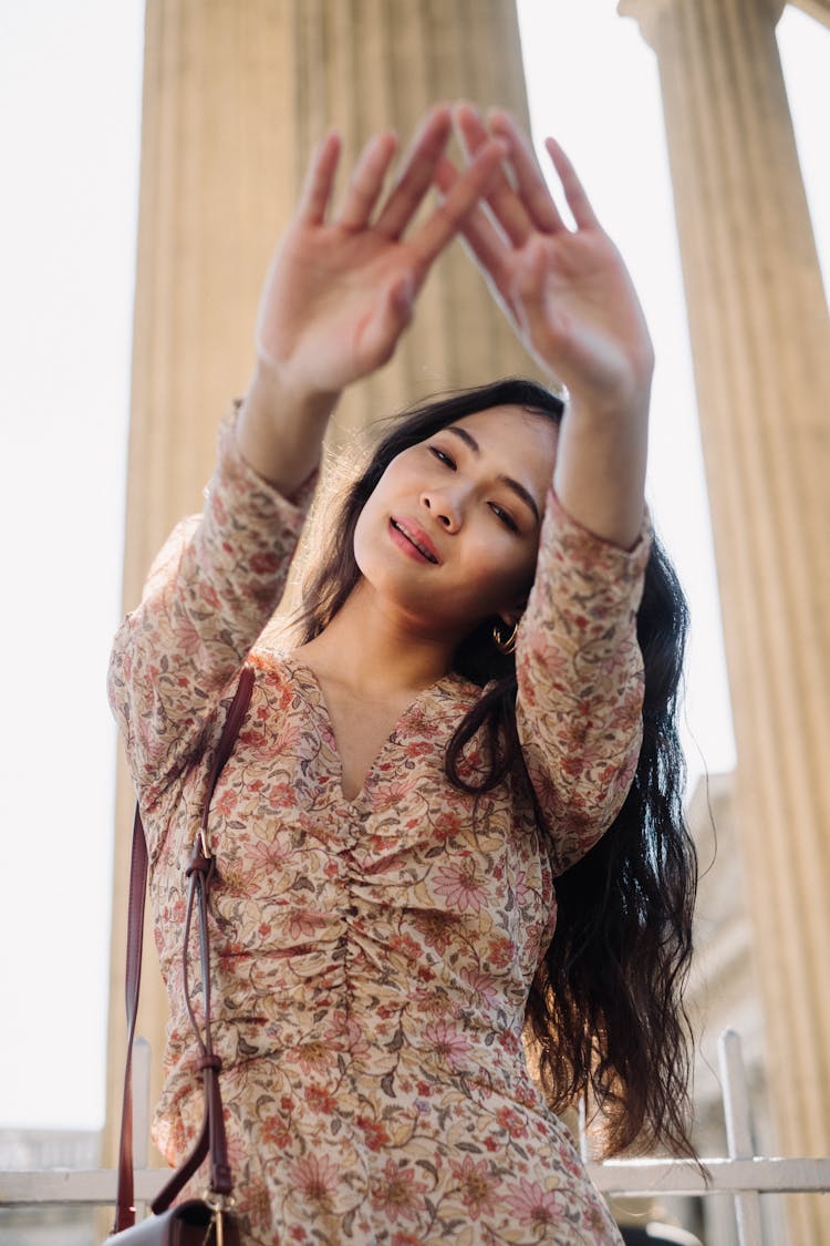 Woman With Closed Eyes And Arms Stretched Over