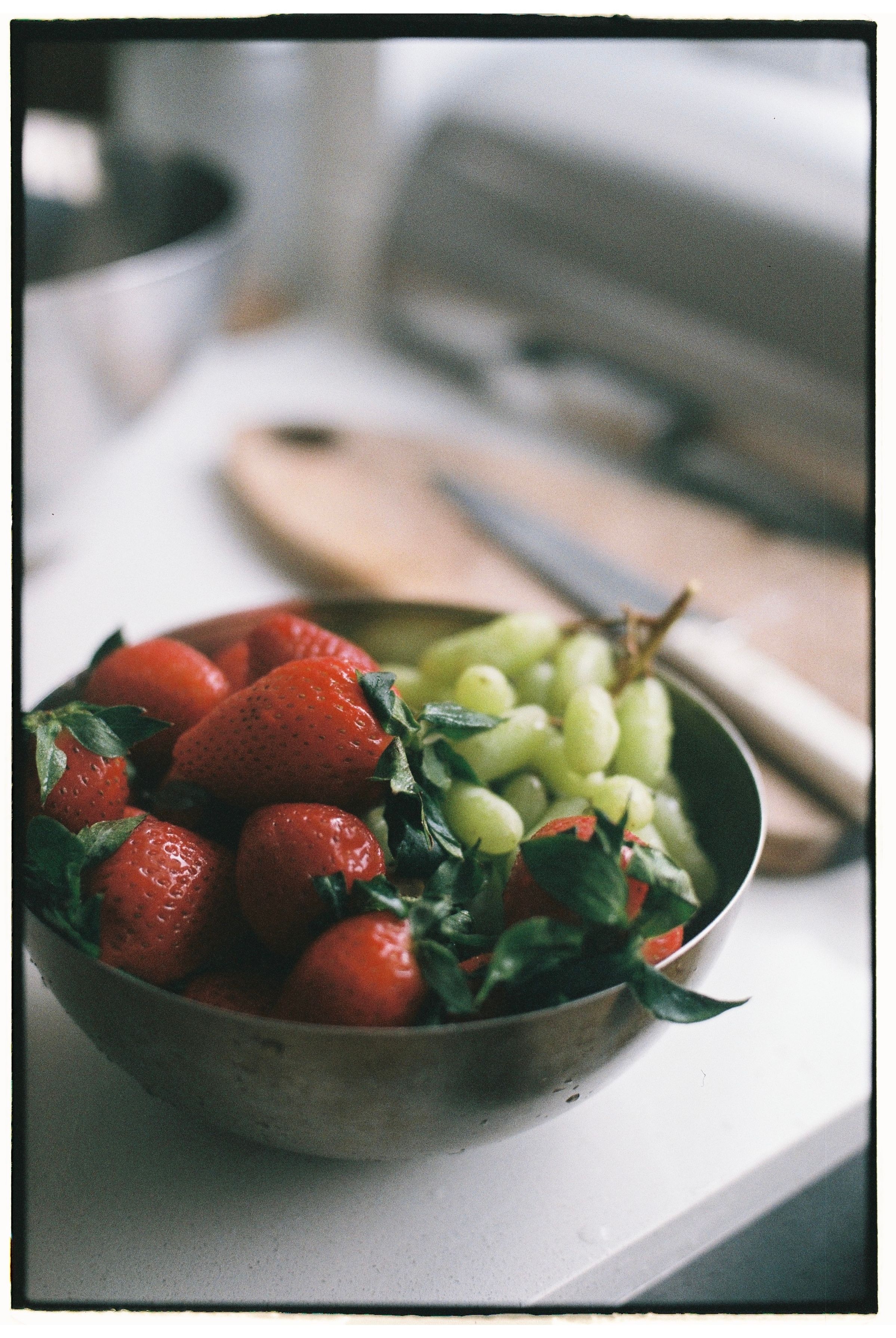 Grapes and fruit left on a kitchen counter