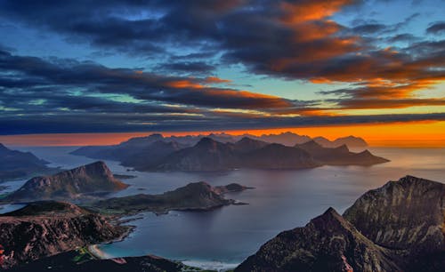 Aerial Photography of Mountains near Ocean during Sunset