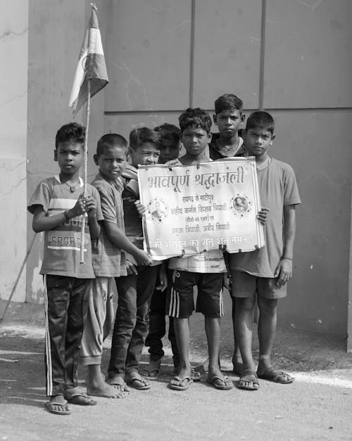 Free Black and White Photo of Boys Holding Posters Stock Photo