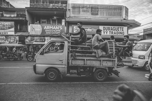Grayscale Photo of Men Riding on Kei Truck