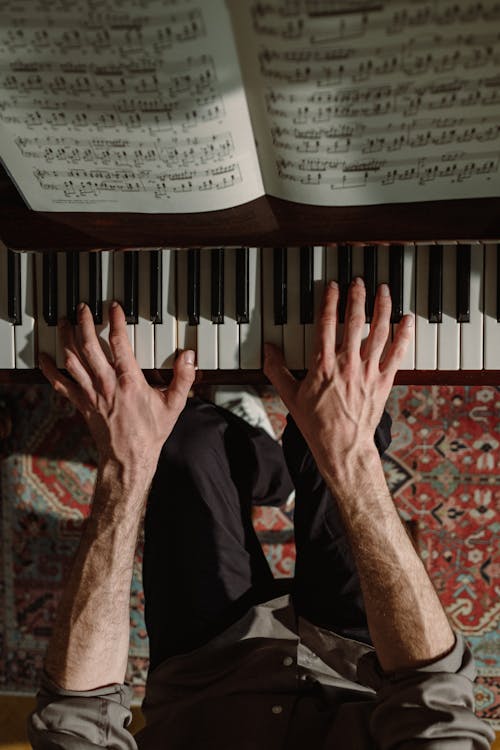 Free High-Angle Shot of a Person Playing Piano Stock Photo