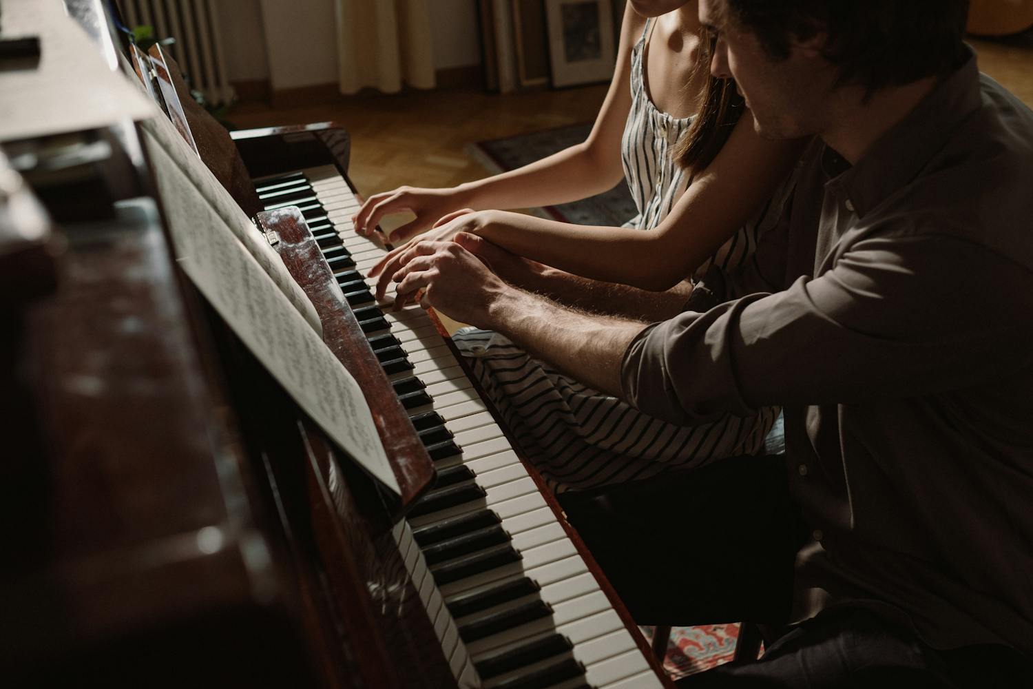 Couple playing piano together