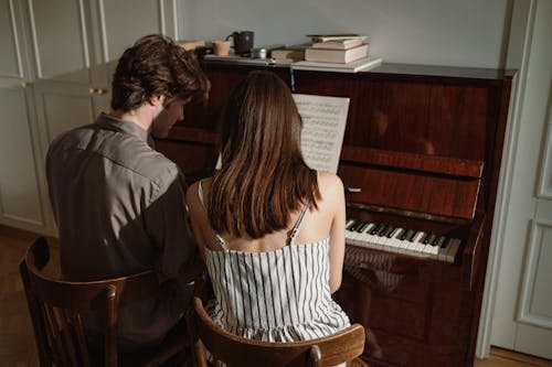 Couple Playing on Piano 