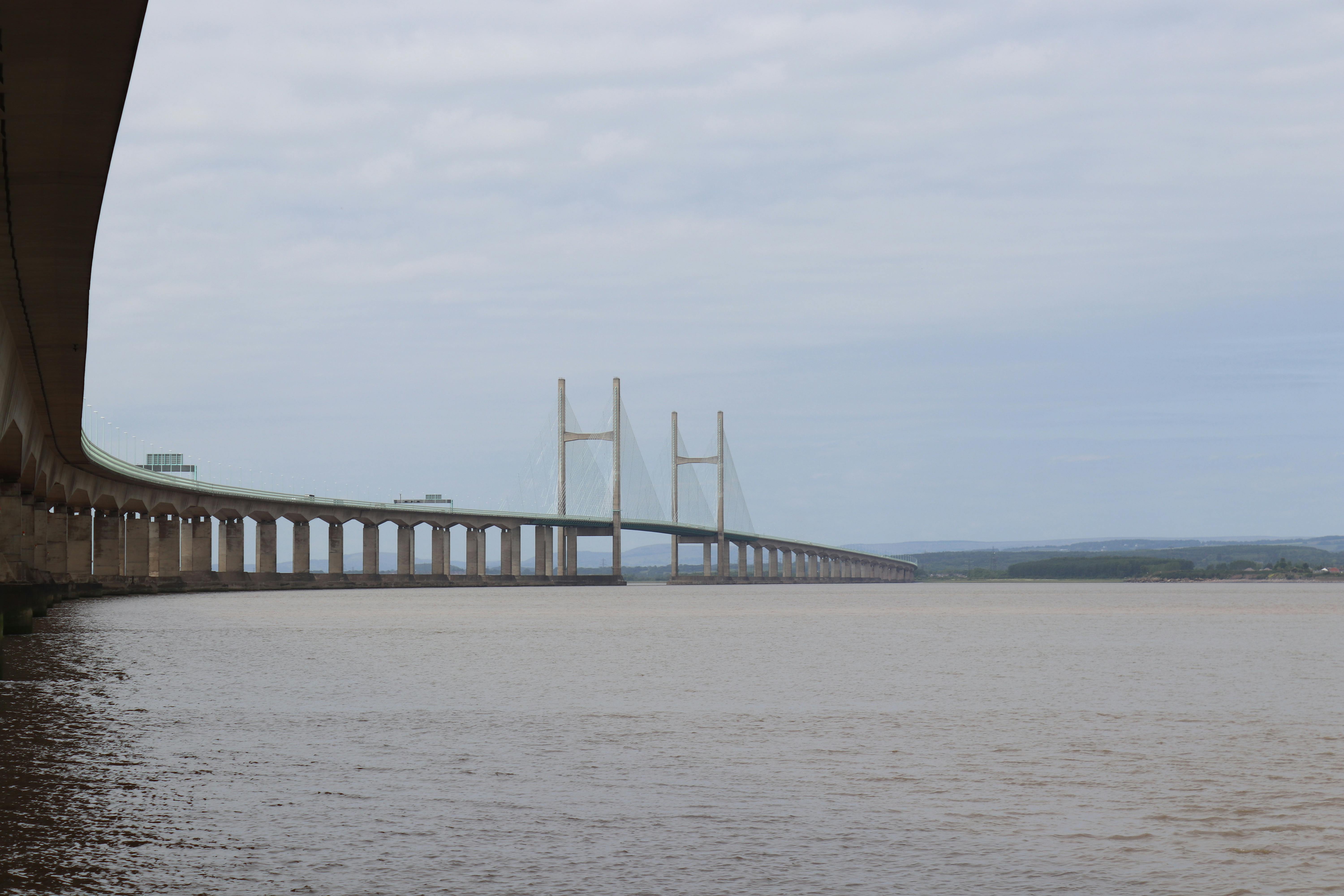 A panoramic view of the Severn Bridge over the tranquil river waters.