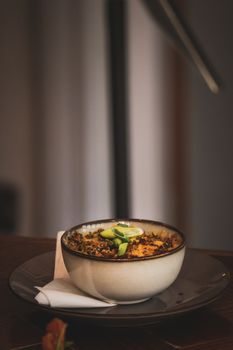 Warm ceramic bowl filled with seasoned quinoa and vegetables, perfect for a cozy meal.