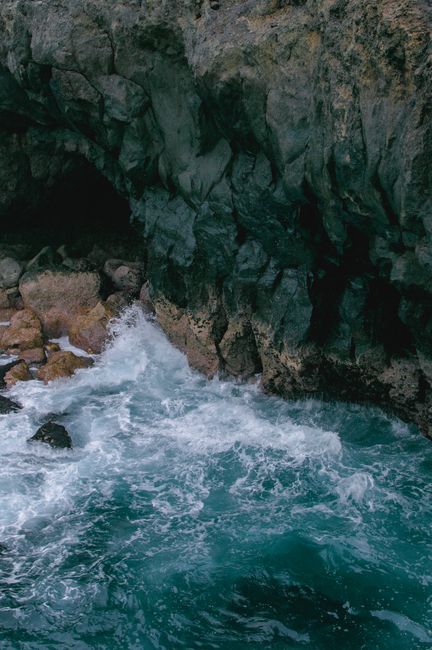 Waves crashing against the rugged cliffs in Santa Cruz de Tenerife, capturing raw coastal beauty.